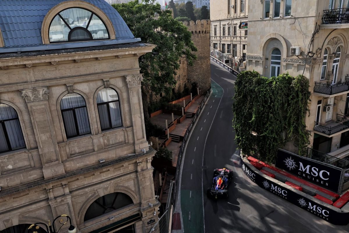 A Red Bull threads between the old-city walls and historic buildings of Baku