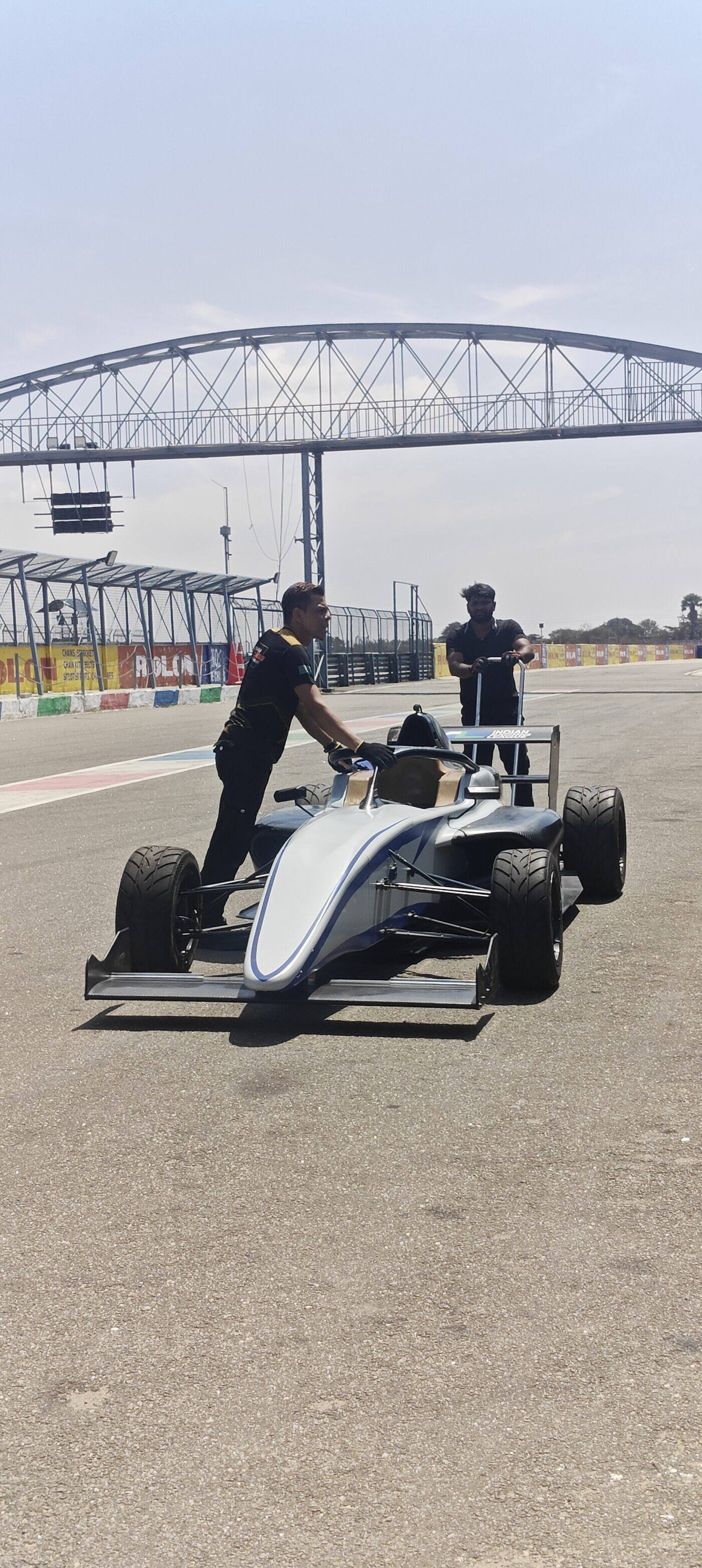 Crew pushing an F4 car onto the track at Kari Motor Speedway for a testing session
