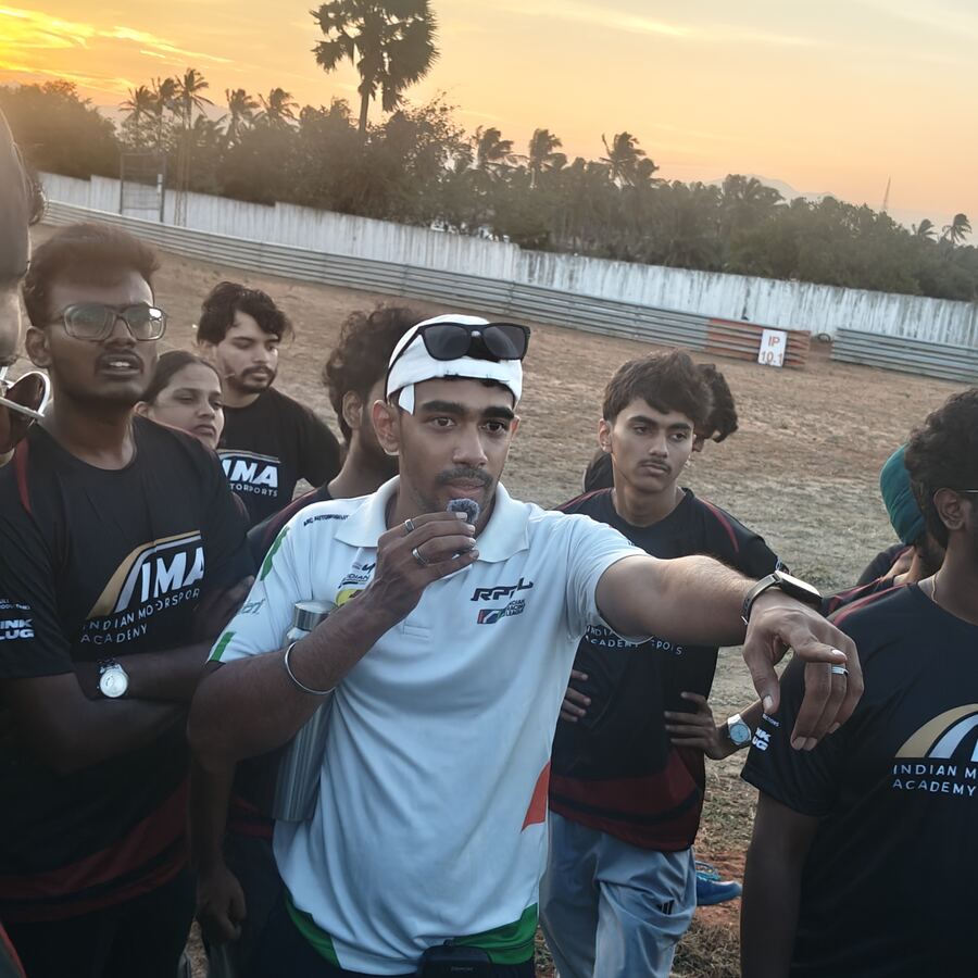 Mentor addressing the group in an outdoor briefing at sunset