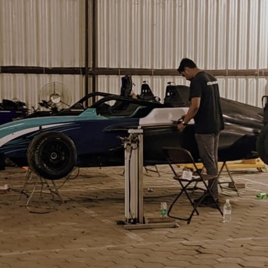 Blue and black F4 car in the workshop at night