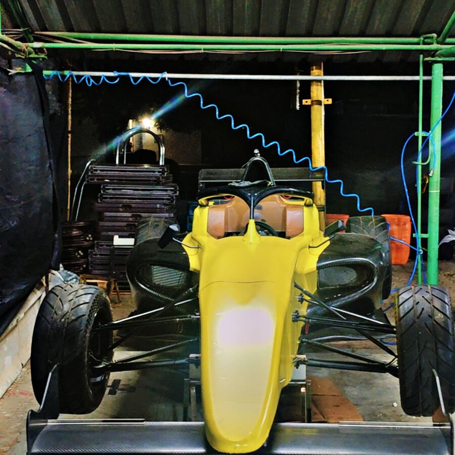 Yellow F4 car front view in the garage
