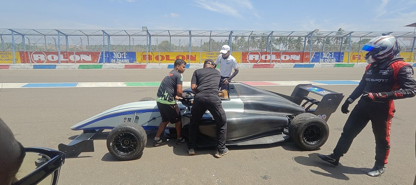 F4 car in the pit lane with mechanics and driver during a shakedown at Kari Motor Speedway