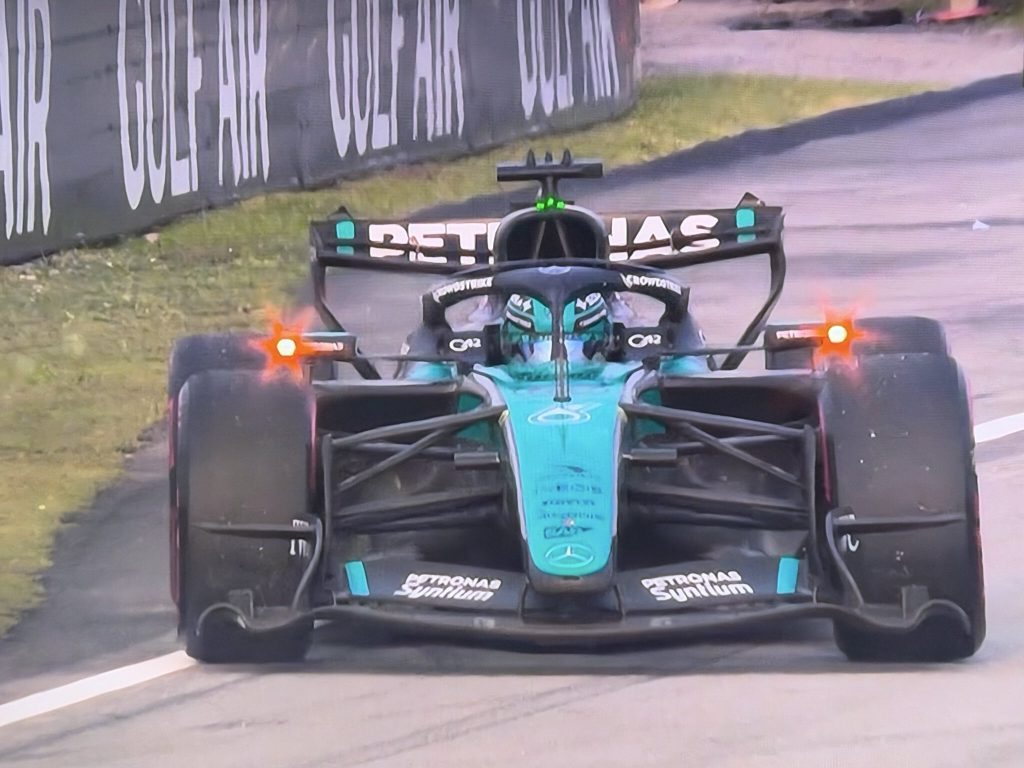 George Russell's Mercedes slowing with its rear lights flashing after the power-unit failure